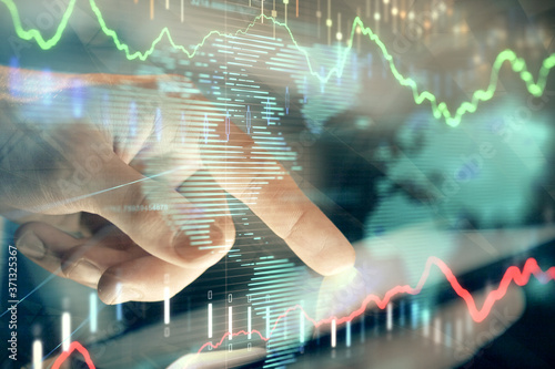 Multi exposure of man's hands holding and using a phone and financial chart drawing. Market analysis concept.