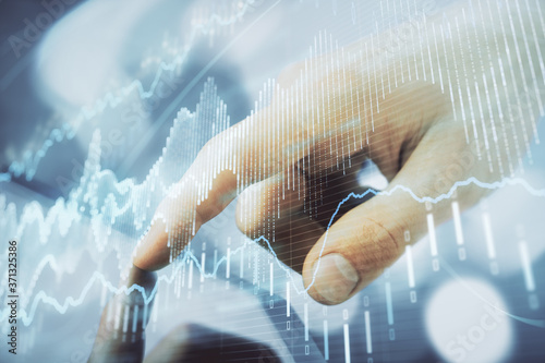 Multi exposure of man s hands holding and using a phone and financial chart drawing. Market analysis concept.