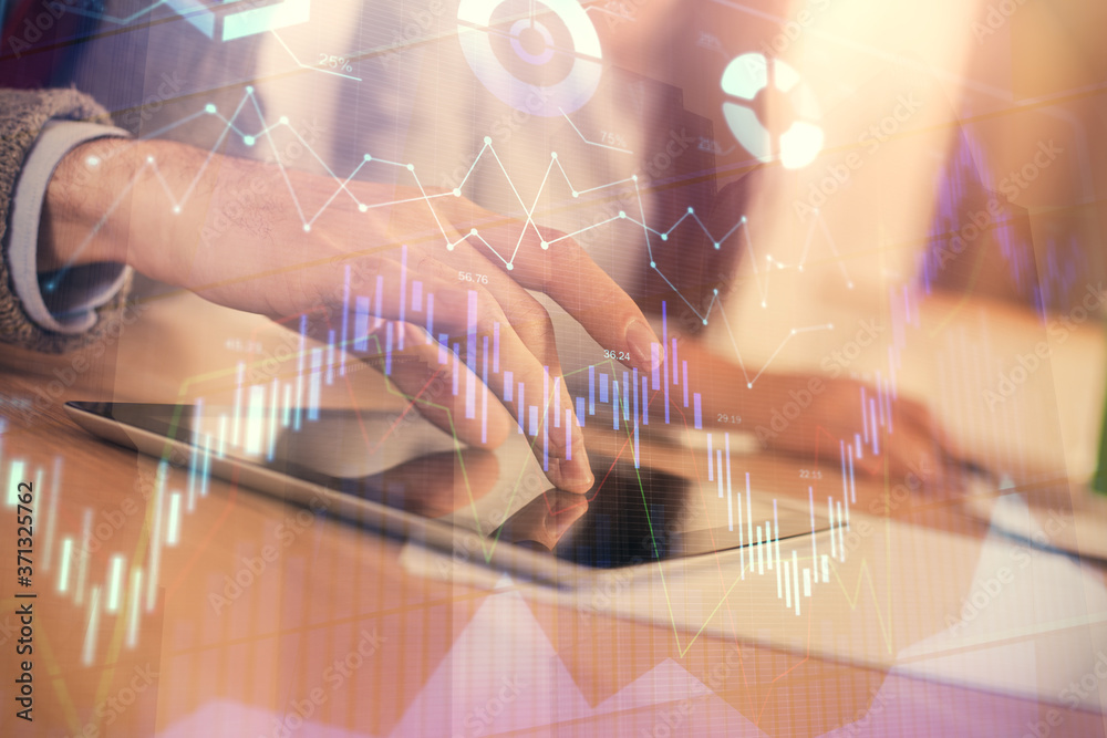 Double exposure of forex graph drawing and man and woman working together holding and using a mobile device. Trade concept.