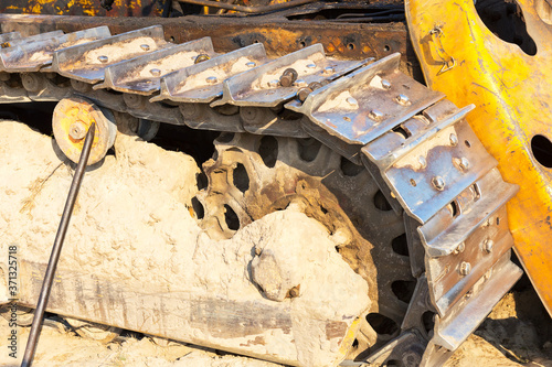 Fragment of tractor tracks. Radioactive dead zone of Chernobyl. Abandoned looted appliances, cars, electronics in Chernobyl accident. Consequences of evacuation, looting, vandalism after an explosion photo