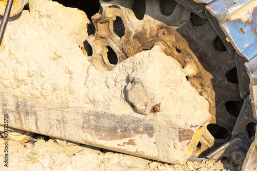 Fragment of tractor tracks. Radioactive dead zone of Chernobyl. Abandoned looted appliances, cars, electronics in Chernobyl accident. Consequences of evacuation, looting, vandalism after an explosion photo