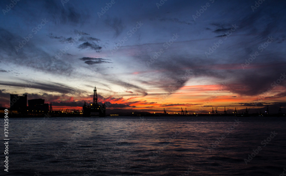 sunset over the sea oil platform