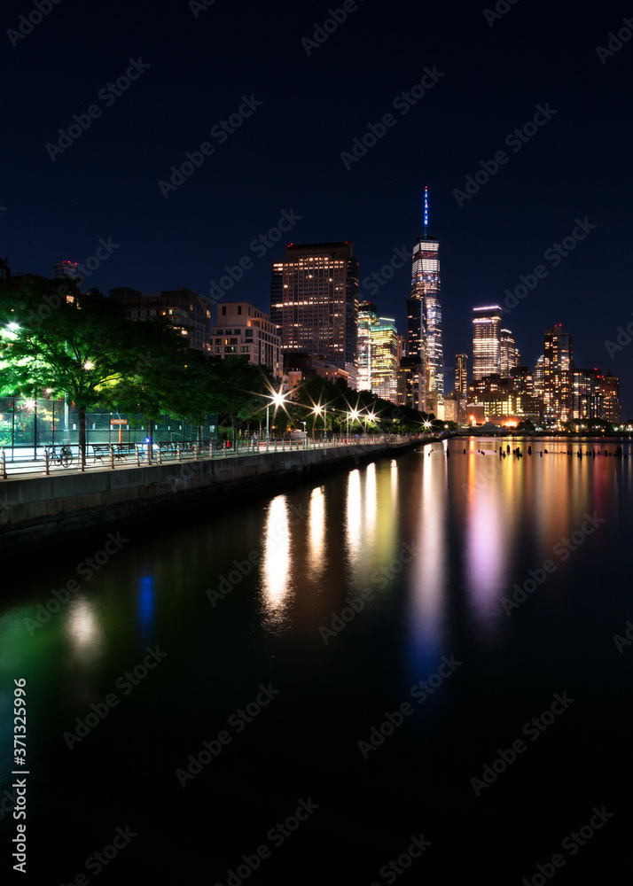 View on Financial District at night with long exposure from Hudson river