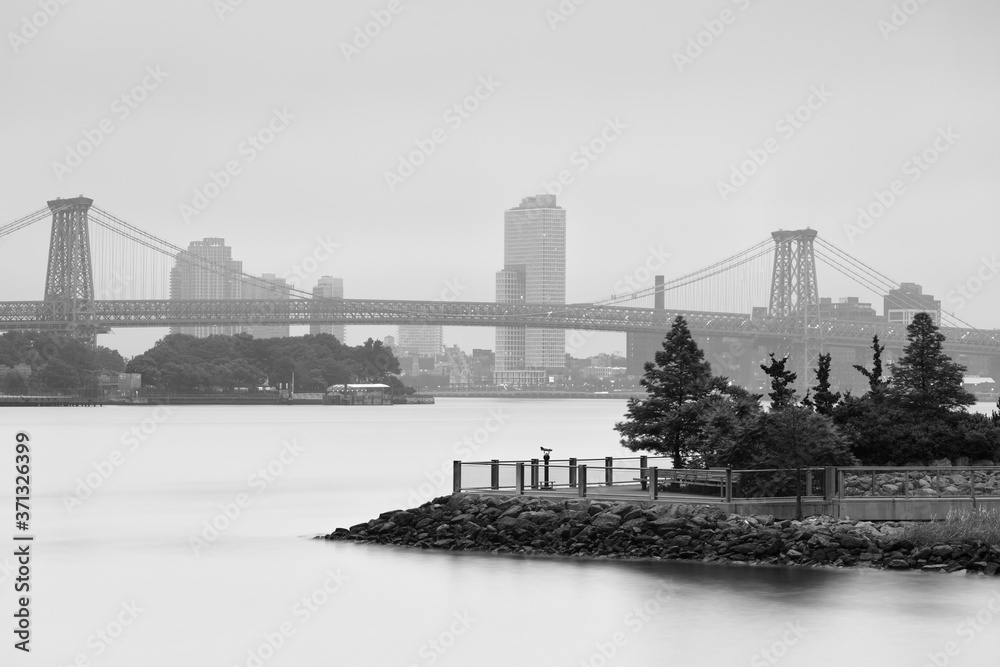 View on Williamsburg bridge on a foggy morning with long exposure in black and white photo