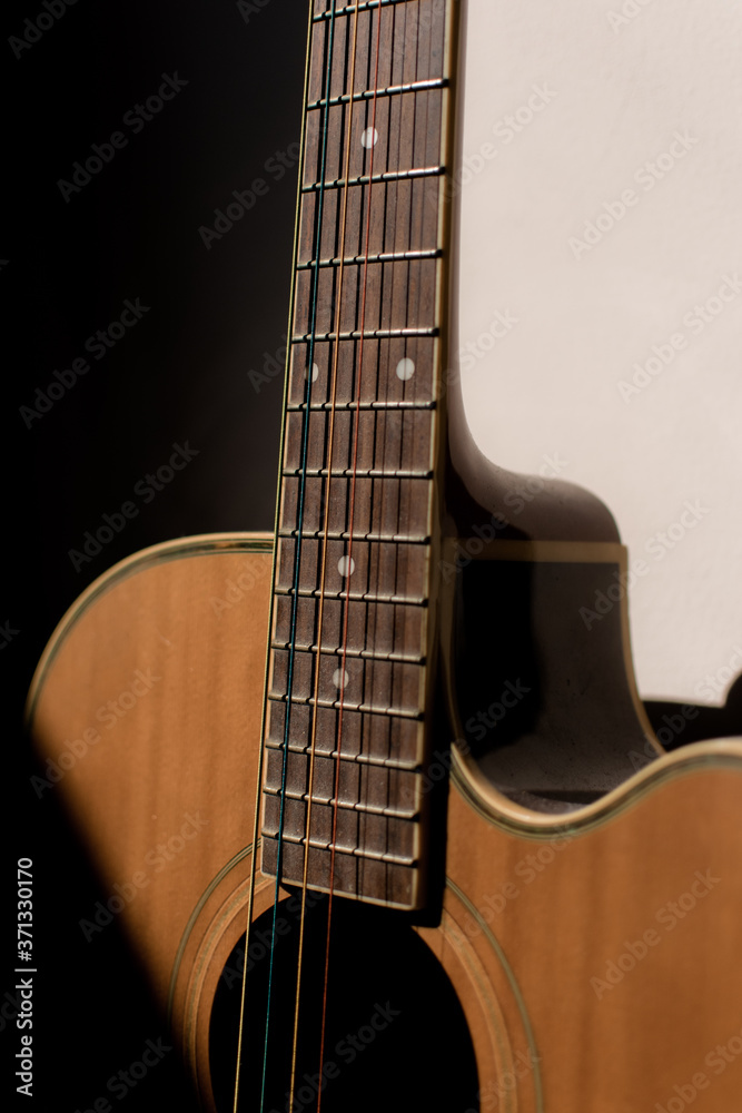 Fototapeta premium Close-up guitar with half sun highlight and shadow