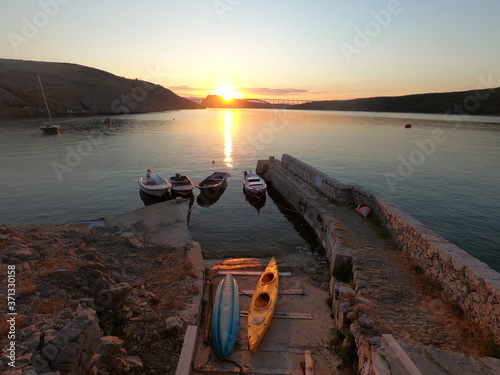 Kayaks and fishing boats in small natural harbour in Maltempo, island Krk, Croatia