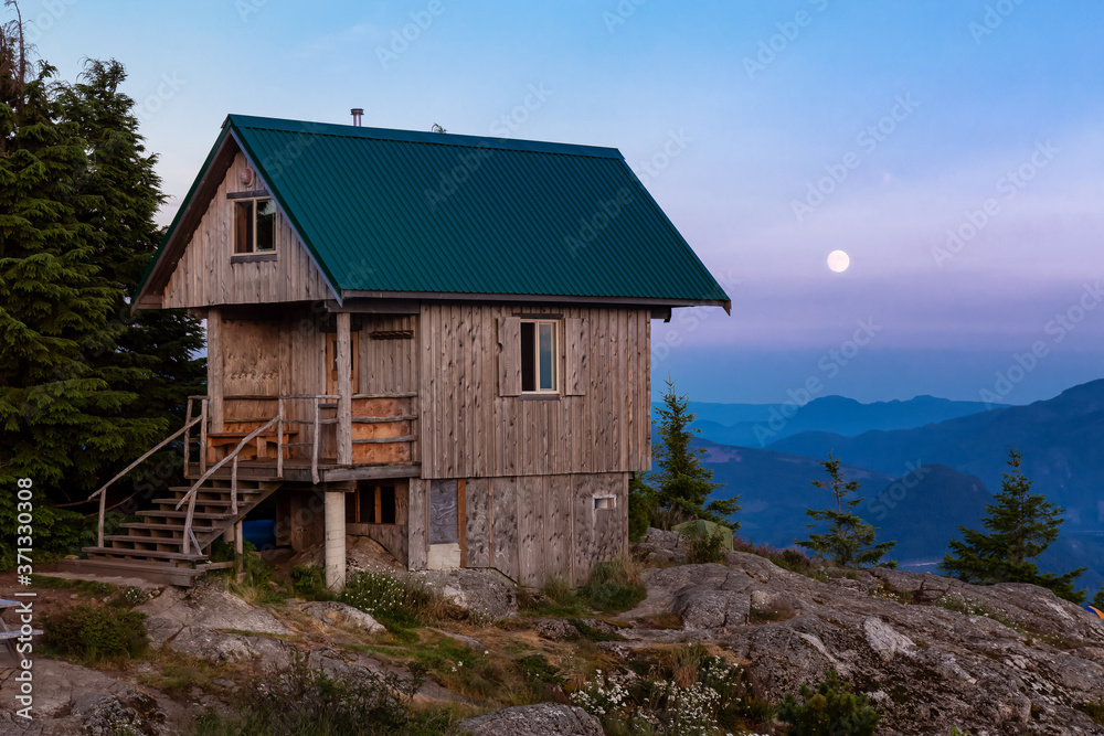 View of Tin Hat Cabin on top of a mountain during a sunny summer sunset. Located near Powell River, Sunshine Coast, British Columbia, Canada.