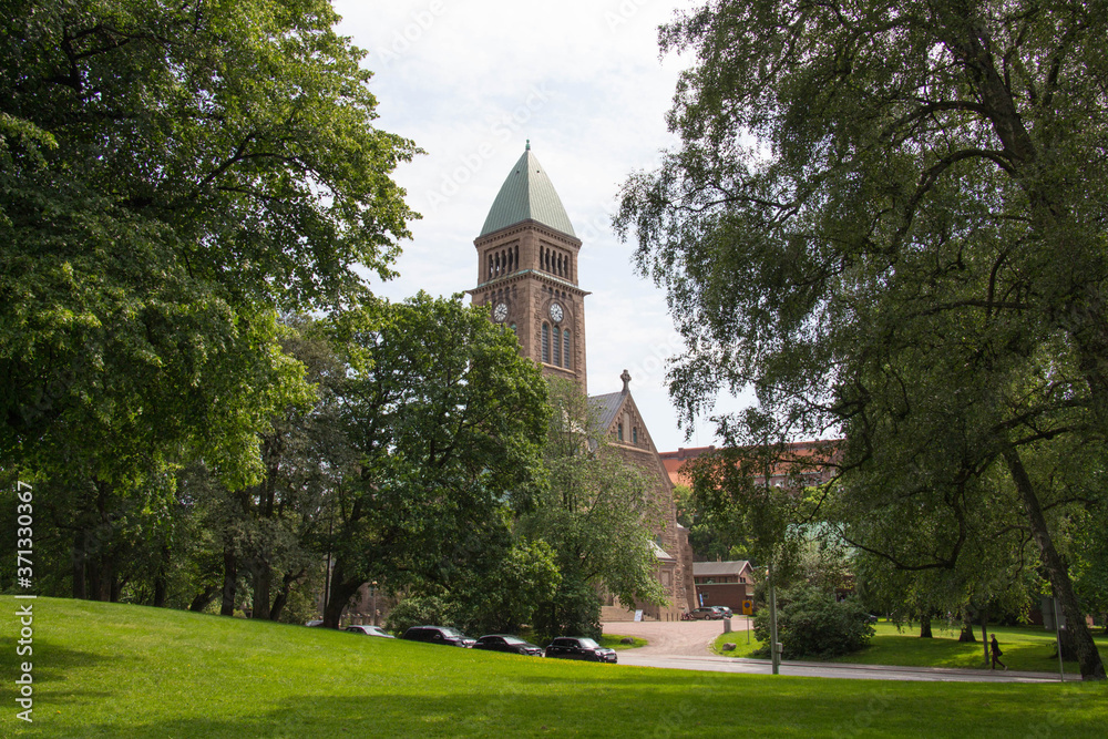 Gothenburg, Sweden - June 18 2019: the view of Vasa Church seeing from trees on June 18 2019 in Gothenburg, Sweden. Gothenburg, Sweden - June 18 2019: the view of Vasa Church seeing from trees on June 18 2019 in Gothenburg, Sweden.