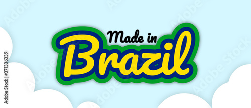 Bold stroke text style "Made in Brazil" vector illustration. Text in country flag colours, floating on editable/removable sky with clouds background.