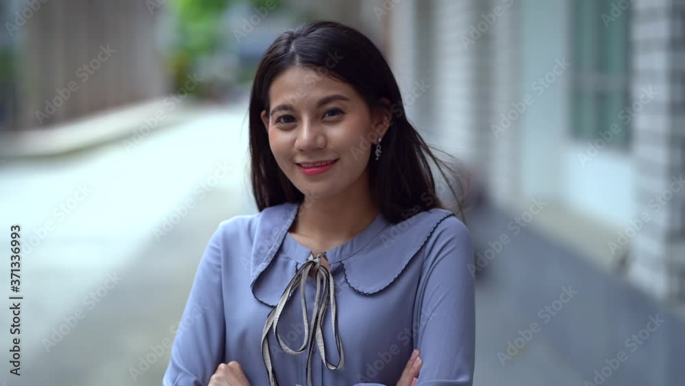 Portrait attractive Asian young smiling woman with black long hair look at camera smile outdoor blur background, Portrait woman happy Portrait attractive Asian young smiling woman with black long hair look at camera smile outdoor blur background, Portrait woman happy