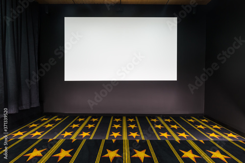 Home cinema with blank movie screen photo