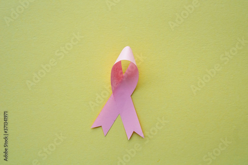 pink ribbon as symbol of fighting breast cancer illness with copy space