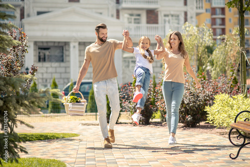 Young cute family walking and looking energized