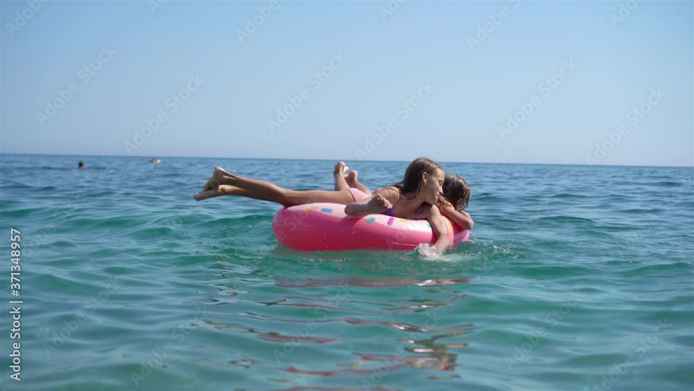 Little girls having fun at tropical beach during summer vacation playing together Little girls having fun at tropical beach during summer vacation playing together