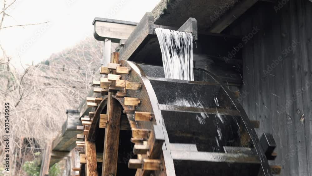 4K Traditional Japanese watermill wheel rotate by stream water at village Saiko Iyashi no sato NENBA in Yamanashi, Japan with beautiful nature in autumn background. 4K Traditional Japanese watermill wheel rotate by stream water at village Saiko Iyashi no sato NENBA in Yamanashi, Japan with beautiful nature in autumn background.
