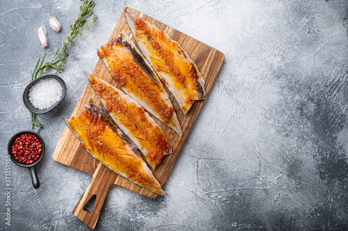 Mackerel marinated with paprika and saffron on grey background, top view with copy space
