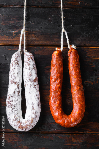 Smoked sausages meat hanging on wooden background