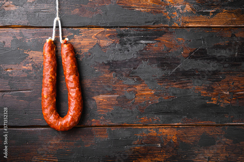 Chorizo sausage on wooden background with copy space