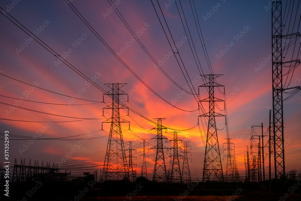 Silhouette High voltage electric tower on sunset time and sky on sunset time background.