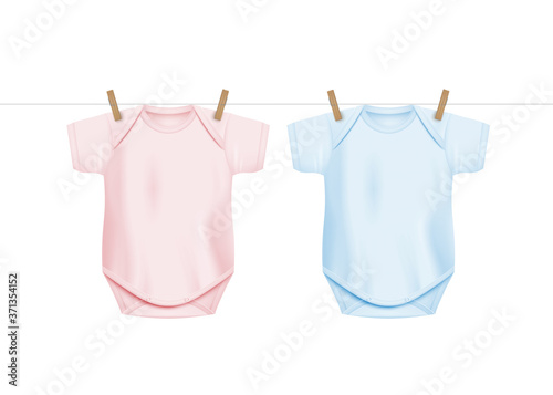 Newborn baby onesie shirts hanging on drying rope with wooden clothes pegs