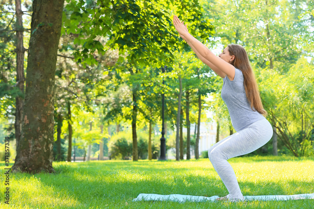 Young pregnant woman practicing yoga outdoors Young pregnant woman practicing yoga outdoors
