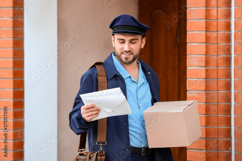 Handsome young postman with...