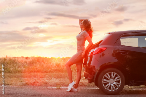 Young woman near car in cou...