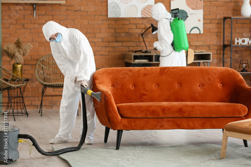 Workers in biohazard costum...