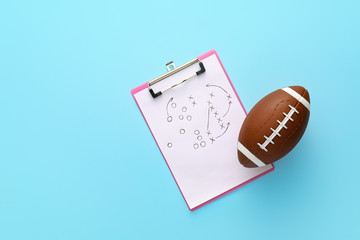 Rugby ball with scheme of football game drawn on color background