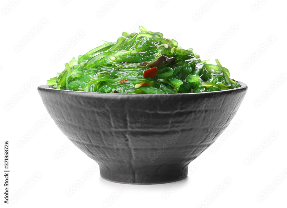 Bowl with tasty seaweed salad on white background