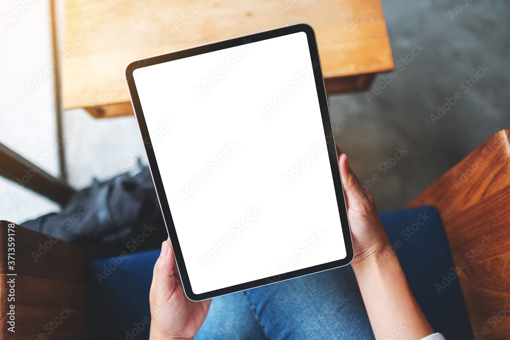 Top view mockup image of a business woman holding black tablet pc with blank white desktop screen