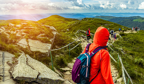 Fototapeta Naklejka Na Ścianę i Meble -  Hiking in the mountains. Bieszczady Poland. Hiker with backpack and jacket.