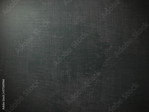 Abstract the texture of an old blackboard with chalk marks.