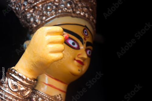 Close up of Goddess Durga with use of selective focus on the hand with rest of the idol blurred 