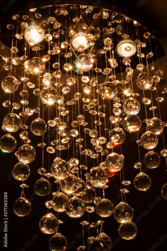 Beautiful crystals of contemporary chandelier lighting. Vertical image