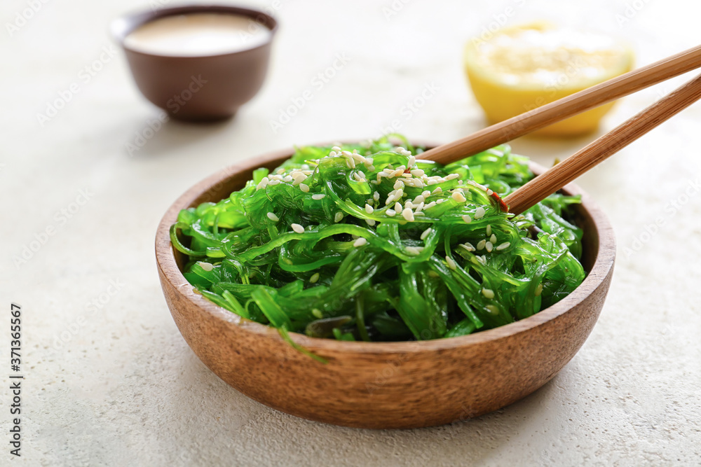 Plate with tasty seaweed salad on white background Plate with tasty seaweed salad on white background