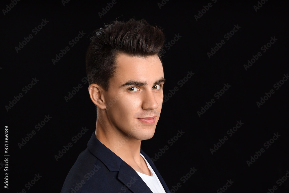 Handsome man with stylish hairdo on dark background Handsome man with stylish hairdo on dark background