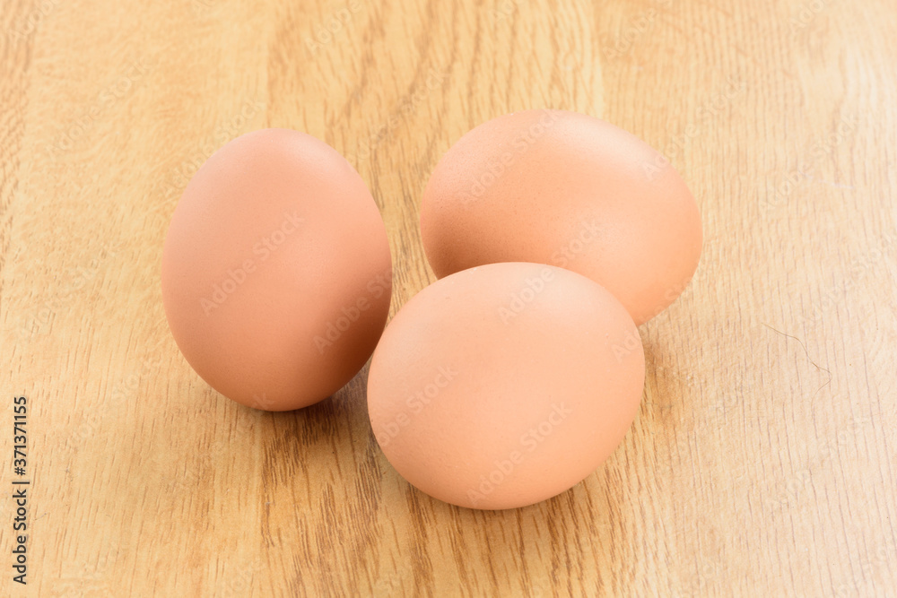 The eggs isolated on the wooden background The eggs isolated on the wooden background