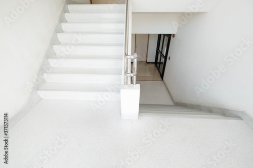 Staircase inside the building. White stairs.