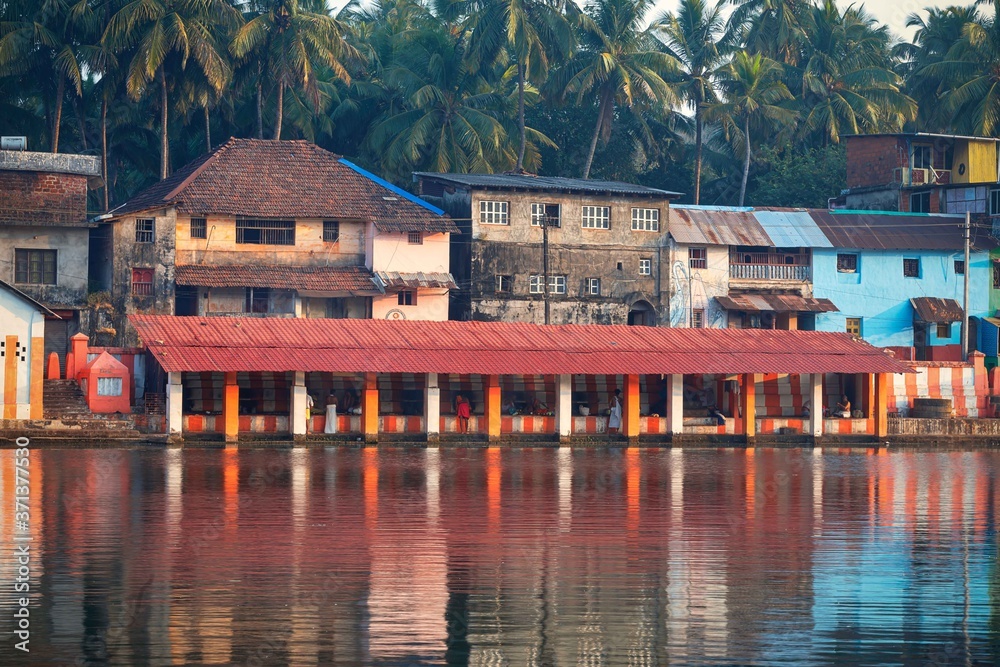 27.12.2019 Gokarna, Karnataka, Colorful indian houses, bright orange-striped temple tank on the bank of sacred lake Koti Teertha. The city is a holy pilgrimage site for Hinduists