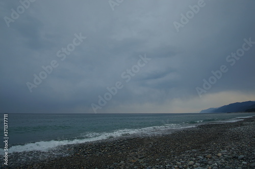 Overcast sky with dark cloud and sea in windy day.