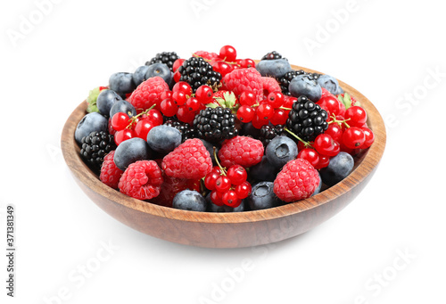 Mix of different fresh berries in bowl on white background