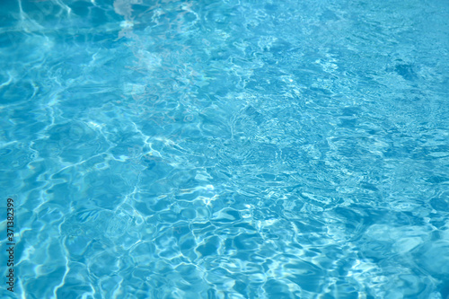 Texture of blue water in swimming pool as background, closeup © New Africa