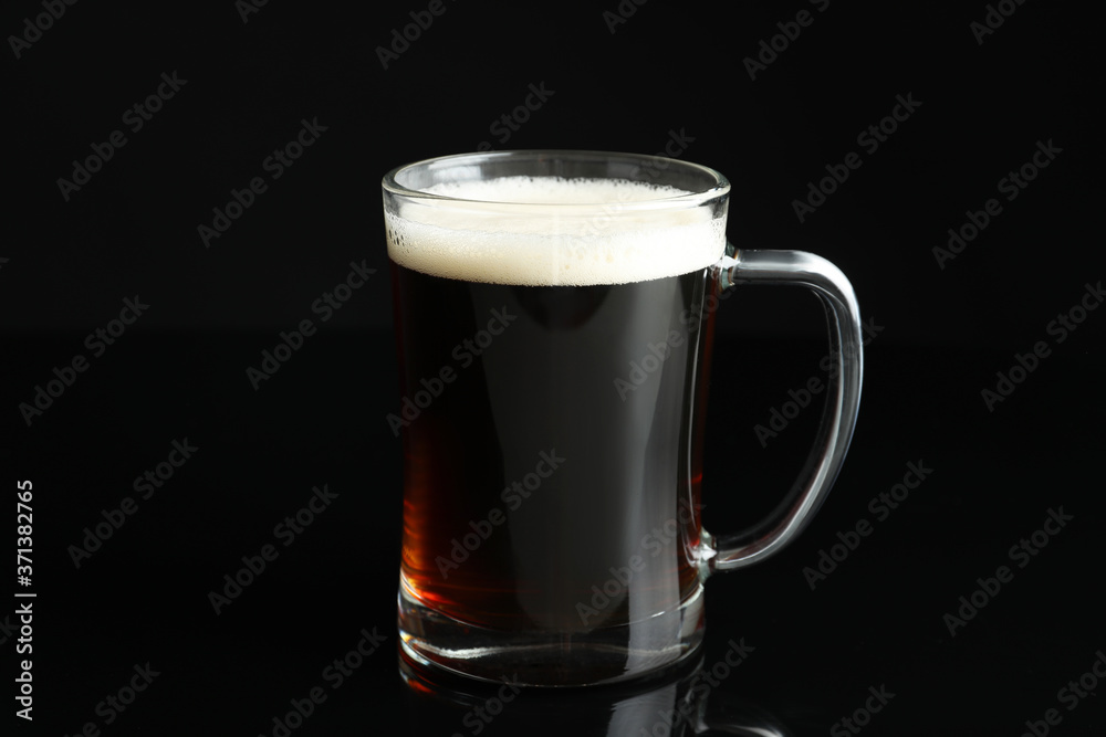 Glass mug of delicious kvass on black background Glass mug of delicious kvass on black background