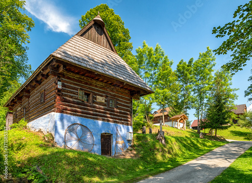 Traditional old wooden cottage with blue facade in village Srnacie - Dolny Kubin, Slovakia photo