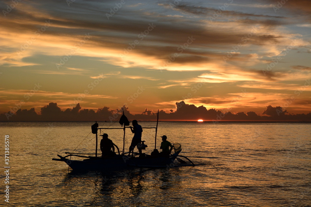 Fishermen silhouettes at sunset. White Beach. Boracay island. Western Visayas. Philippines