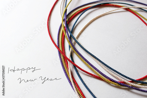Five colors strings on white background happy new year greeting card