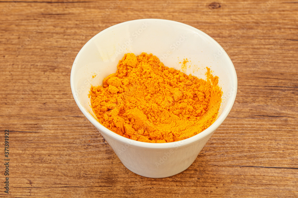 Tumeric powder in the bowl Tumeric powder in the bowl