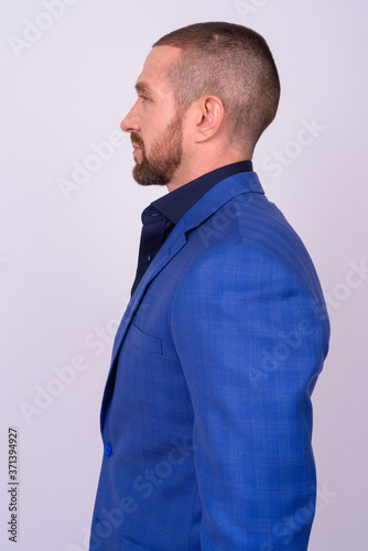 Portrait of handsome bald bearded businessman in suit © Ranta Images