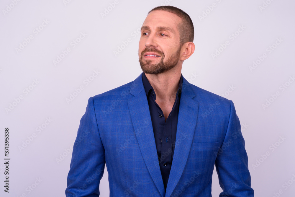 Portrait of happy handsome bald bearded businessman in suit Portrait of happy handsome bald bearded businessman in suit